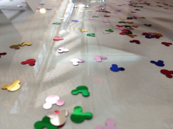 Multi-colored Mickey Mouse shaped confetti on table