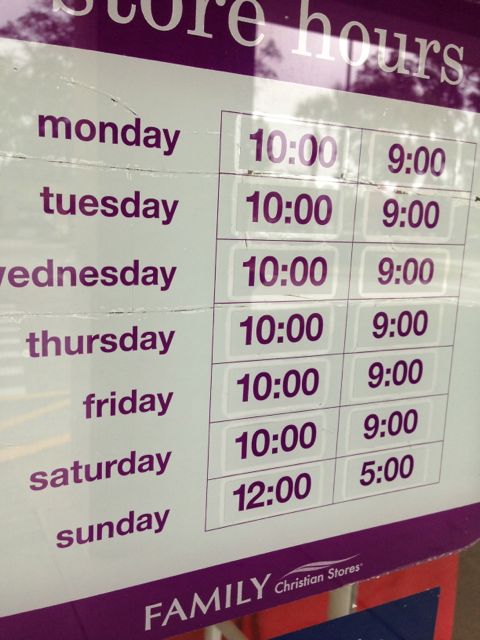 Store hours sign on shop's front door