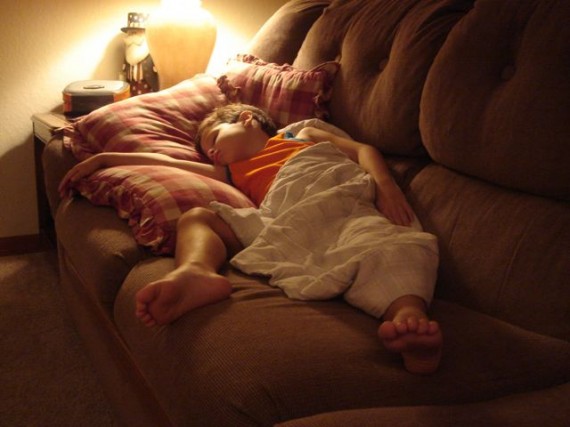 small boy asleep on couch