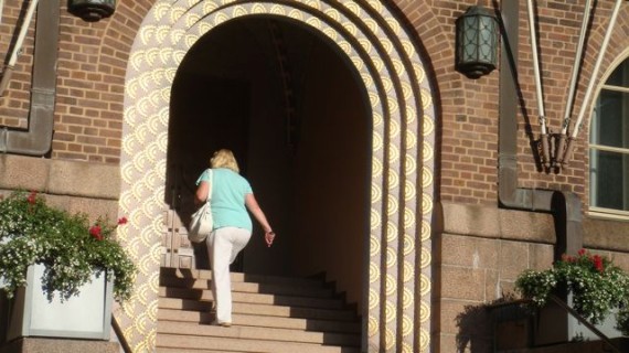 Woman climbing stairs on bright Summer morning