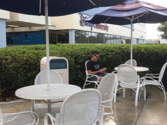 Man sitting at Disney University's outdoor break area