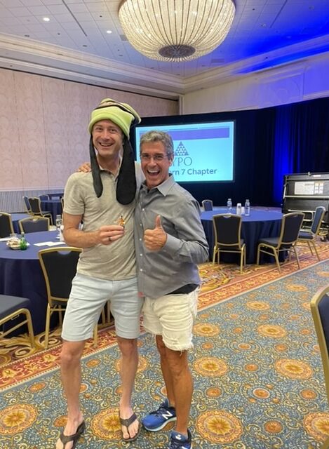 Disney keynote speaker Jeff Noel with man in Goofy hat