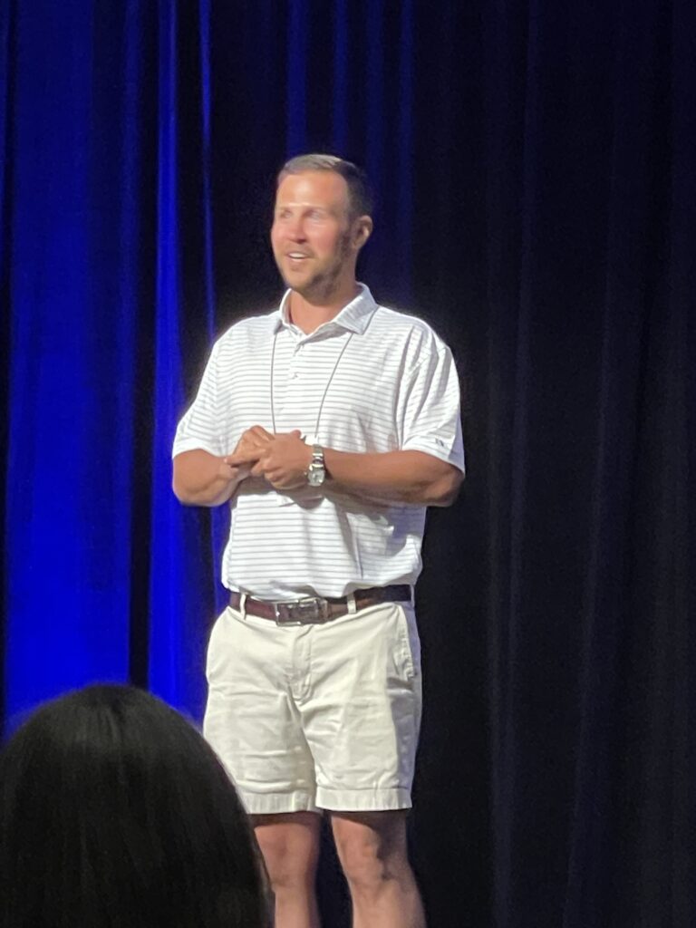 Business executive on stage in shorts