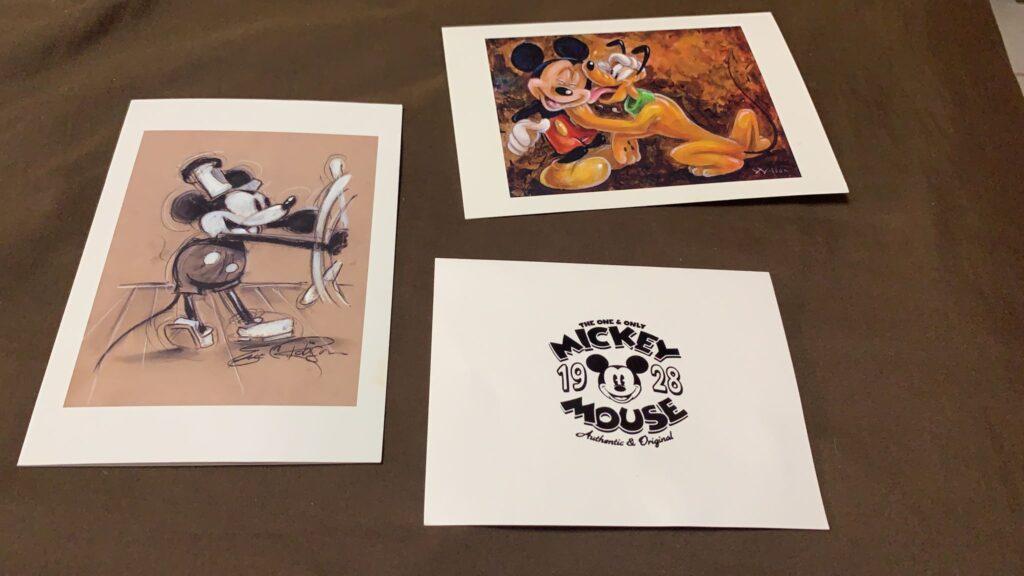 three Mickey Mouse note cards on a table
