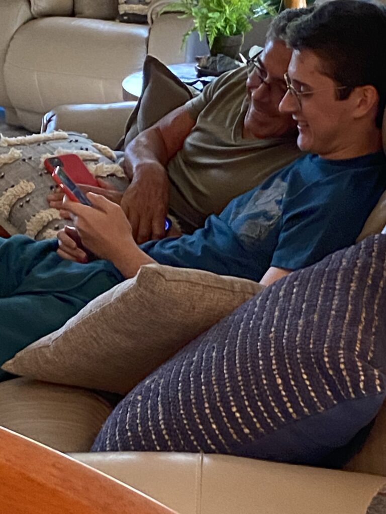 Father and son sitting on couch