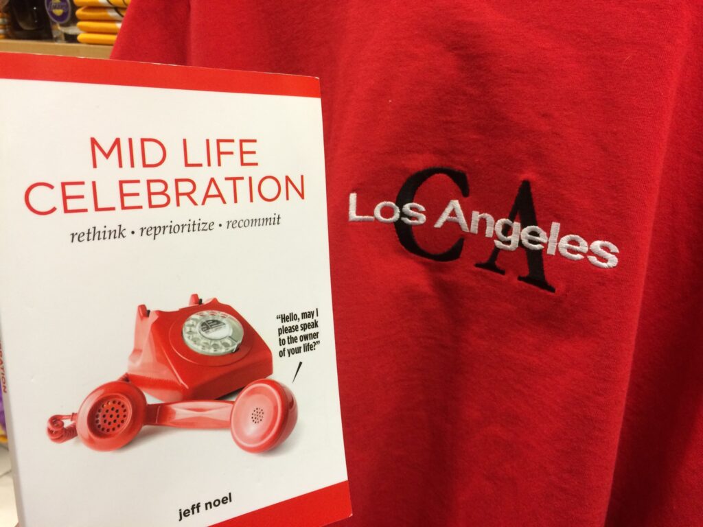 Mid Life Celebration book and Los Angeles tee shirt