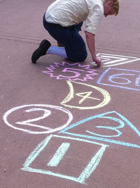 Disney Cast Member creating sidewalk chalk art