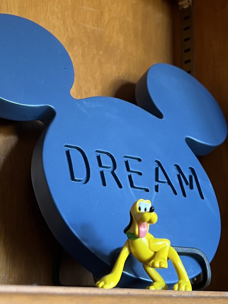 Disney image and small Pluto toy character