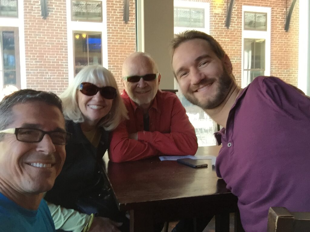 four adults at a cafe