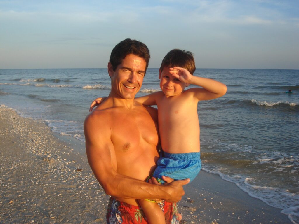 Father and son at beach sunset