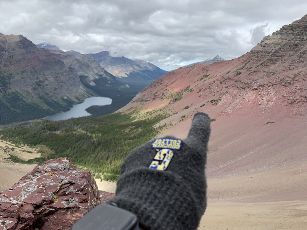 person pointing to a mountain