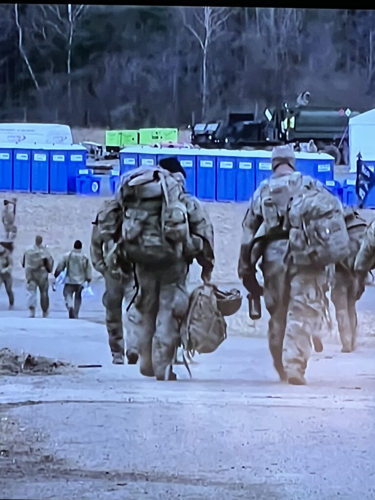 US Troops walking at base camp
