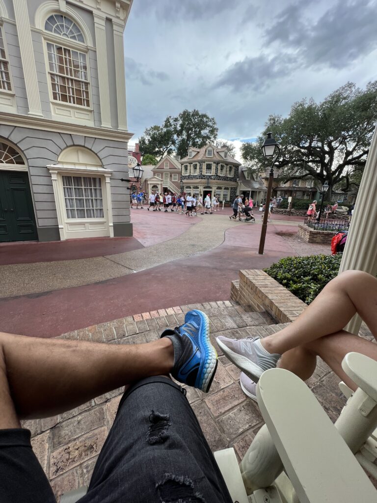 couple sitting on two rocking chairs at Disney's Magic Kingdom