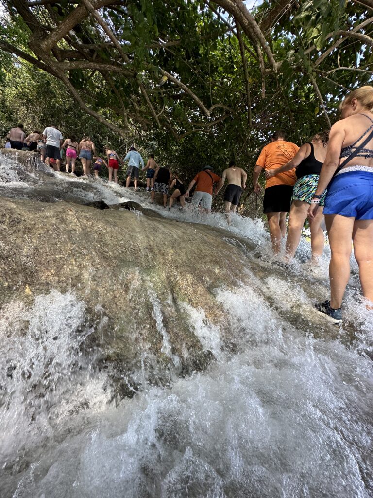 Tourists Walking a line holding hands.