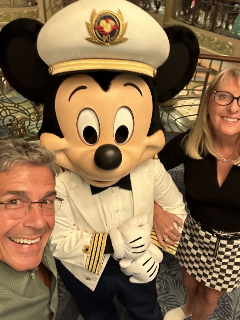 Couple posing with Mickey Mouse 